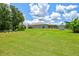 Large backyard with lush green grass, fenced perimeter and exterior home view at 5954 Gottfried Ln, North Port, FL 34291