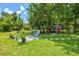 Inviting outdoor patio area with comfortable seating nestled amongst lush greenery and landscaping at 5954 Gottfried Ln, North Port, FL 34291