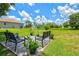 Patio seating area with a view of a large grassy backyard, shed, and a home's exterior at 5954 Gottfried Ln, North Port, FL 34291