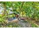 Backyard view showcasing chicken coop under the natural shading at 5954 Gottfried Ln, North Port, FL 34291