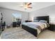 The bedroom has a spacious gray rug, a computer desk, and a large window with a view to the outside at 5954 Gottfried Ln, North Port, FL 34291