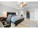 The bedroom features a closet, ceiling fan, and a view to the bathroom and walk in closet at 5954 Gottfried Ln, North Port, FL 34291