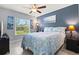 This bedroom features a coastal theme with a nautical quilt, a ceiling fan, and natural light from the window at 5954 Gottfried Ln, North Port, FL 34291
