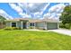 Lovely one-story home with an attached garage, a well-maintained lawn, and neatly trimmed landscaping at 5954 Gottfried Ln, North Port, FL 34291