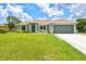 Inviting single-story home with lush front lawn and attached two-car garage at 5954 Gottfried Ln, North Port, FL 34291