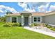 Charming single-story home with well-manicured lawn and landscaping at 5954 Gottfried Ln, North Port, FL 34291