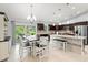 Well-appointed kitchen featuring granite counters, stainless appliances, breakfast bar, and dining table at 5954 Gottfried Ln, North Port, FL 34291