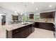 Spacious kitchen boasting granite counters, stainless appliances, and center island next to the dining area at 5954 Gottfried Ln, North Port, FL 34291