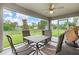 Screened patio with a table and four chairs overlooks the backyard and a serene canal at 5954 Gottfried Ln, North Port, FL 34291
