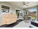 Covered patio with outdoor seating, ceiling fan, and grill for entertaining with a backyard view at 5954 Gottfried Ln, North Port, FL 34291
