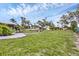 Expansive backyard featuring lush greenery, mature trees, and a well-manicured landscape at 612 Bayshore Rd, Nokomis, FL 34275