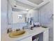 Bathroom with a vanity and sink, along with a large mirror and wallpapered walls at 612 Bayshore Rd, Nokomis, FL 34275