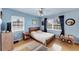 Cozy bedroom with natural light, wood floors, and neutral-toned walls with tasteful decor at 612 Bayshore Rd, Nokomis, FL 34275