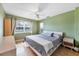 Comfortable bedroom with an overhead fan and light streaming through the large window at 612 Bayshore Rd, Nokomis, FL 34275