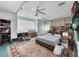 Spacious bedroom with a ceiling fan, large window, and a comfortable bed on top of a colorful rug at 612 Bayshore Rd, Nokomis, FL 34275