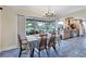 Inviting dining room with views of the lanai and a well-equipped kitchen in the background at 612 Bayshore Rd, Nokomis, FL 34275