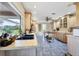 Spacious kitchen featuring custom wood cabinets, tile countertops, and natural lighting at 612 Bayshore Rd, Nokomis, FL 34275