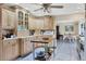 Kitchen with wooden cabinets, an island prep area, recessed lighting, and tile flooring at 612 Bayshore Rd, Nokomis, FL 34275