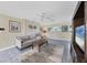 Bright living room with tile floors, a comfortable sofa, and a decorative ceiling fan at 612 Bayshore Rd, Nokomis, FL 34275