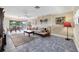 Relaxing living room showing a comfortable sofa, tile floors, and a view to an outdoor dining area at 612 Bayshore Rd, Nokomis, FL 34275