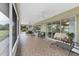 Covered and screened patio featuring tile floors and furniture, ideal for outdoor relaxation at 612 Bayshore Rd, Nokomis, FL 34275