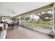 Spacious screened porch with tile flooring and views of the landscaped backyard at 612 Bayshore Rd, Nokomis, FL 34275