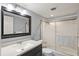 Bathroom features a large vanity, a toilet, and a bathtub with a glass shower door at 614 Guild Dr # 10, Venice, FL 34285