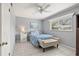 Cozy bedroom with a ceiling fan, window, and blue bedding at 614 Guild Dr # 10, Venice, FL 34285