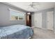Comfortable bedroom with tile flooring, a large window, and a closet with sliding doors at 614 Guild Dr # 10, Venice, FL 34285