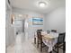 Bright dining area with tile floors, coastal decor, and a dining table at 614 Guild Dr # 10, Venice, FL 34285