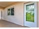 Exterior view showing the front door of unit 10, with stucco facade and window for natural light at 614 Guild Dr # 10, Venice, FL 34285