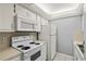 Functional kitchen features a white refrigerator, white cabinets, and a white oven with stovetop at 614 Guild Dr # 10, Venice, FL 34285