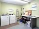 A community laundry room with two washing machines, storage shelving, and a folding counter for convenience at 614 Guild Dr # 10, Venice, FL 34285