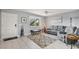 Inviting living area with tile floors, gray sofa, and large window with natural light at 614 Guild Dr # 10, Venice, FL 34285