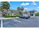 Building exterior showcasing well-maintained landscaping, parking, stairs and condo exteriors on a sunny day at 614 Guild Dr # 10, Venice, FL 34285