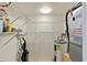 Organized storage area with wire shelving, water heater, and air conditioning unit for efficient space and utility management at 614 Guild Dr # 10, Venice, FL 34285