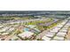 Community aerial view featuring pool, tennis courts, clubhouse, and boat docks along canal at 614 N Waterway, Venice, FL 34285