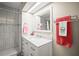 Modern bathroom featuring shower with glass doors, a white vanity, and marble countertop at 614 N Waterway, Venice, FL 34285