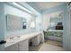 Attached bathroom features a large vanity, mirror, and a peek of the bedroom at 614 N Waterway, Venice, FL 34285