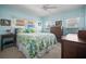 Bright bedroom with pastel blue walls, wood furniture, and large windows with views at 614 N Waterway, Venice, FL 34285