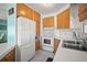 Functional kitchen with wooden cabinets, white countertops, and modern appliances, offering ample storage at 614 N Waterway, Venice, FL 34285