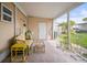 Spacious covered patio with stone flooring and views of the manicured lawn at 614 N Waterway, Venice, FL 34285
