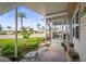 Inviting outdoor space, with green chairs, leading to a screened-in porch of a well maintained home at 614 N Waterway, Venice, FL 34285