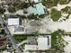 Aerial view of a vacant lot on a street, surrounded by greenery, showcasing its location and potential at 616 S Casey Key Rd, Nokomis, FL 34275