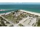 Extensive aerial view highlights a beach park with parking and bath house near water and docks at 616 S Casey Key Rd, Nokomis, FL 34275