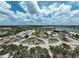 Wide aerial view shows a sandy beach area with parking, trees and a glimpse of the scenic bay at 616 S Casey Key Rd, Nokomis, FL 34275