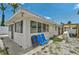 Backyard of the home, with a patio, gravel, and an exterior view of the home at 616 S Casey Key Rd, Nokomis, FL 34275