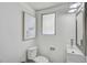 Compact half-bathroom with a white vanity, a matching toilet, and a window at 616 S Casey Key Rd, Nokomis, FL 34275