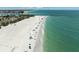 A sun-soaked beach with scattered beach-goers, showcasing the inviting turquoise waters and clear skies at 616 S Casey Key Rd, Nokomis, FL 34275