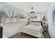Bright bedroom featuring wood floors, a ceiling fan and two windows at 616 S Casey Key Rd, Nokomis, FL 34275